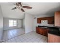 Spacious living room and kitchen featuring gray walls, tile floors and ceiling fan at 3646 N 69Th Ave # 4, Phoenix, AZ 85033