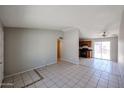 View of the open living room with tile floors flowing into the kitchen at 3646 N 69Th Ave # 4, Phoenix, AZ 85033