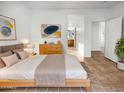 Serene main bedroom with a bed, dresser, and ensuite bathroom access with neutral decor at 41220 N Belfair Way, Anthem, AZ 85086