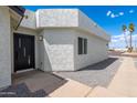 A contemporary home featuring a modern front door and neutral toned stucco exterior at 5109 W Sanna St, Glendale, AZ 85302
