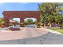 Welcoming community entrance with brick archway, fountain, and lush landscaping at 521 E Horseshoe Ave, Gilbert, AZ 85296