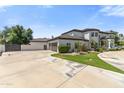 Charming home showcasing a large driveway and a three-car garage at 521 E Horseshoe Ave, Gilbert, AZ 85296