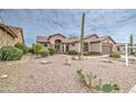 Inviting home featuring desert landscaping, mature cacti, and a neutral-toned exterior at 5289 S Red Yucca Ln, Gold Canyon, AZ 85118
