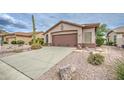 A two-car garage, desert landscaping, and neutral exterior define the home's curb appeal at 5289 S Red Yucca Ln, Gold Canyon, AZ 85118
