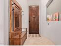 Welcoming foyer featuring a custom hall tree and a wooden door, creating a warm and inviting entry at 5370 S Desert Dawn Dr # 30, Gold Canyon, AZ 85118