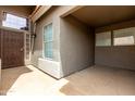 View of the home's covered entryway with security door and neutral paint colors at 6014 E Sayan Cir, Mesa, AZ 85215