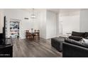 Open-concept living and dining area with wood floors and an abundance of natural light at 7416 S Mcallister Ave, Tempe, AZ 85283