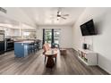 Bright living room with wood-look flooring, a ceiling fan, and access to the outdoor living space at 7416 S Mcallister Ave, Tempe, AZ 85283