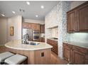 Spacious kitchen with stainless steel appliances, granite countertops, and a large island with seating at 8964 E Mountain Spring Rd, Scottsdale, AZ 85255
