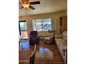 Inviting living room with hardwood floors, lots of natural light, and comfortable seating at 907 E Lancaster Cir, Florence, AZ 85132