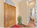 Inviting entryway featuring a wooden door, tile flooring, and neutral paint, creating a warm ambiance at 9327 E Whitewing Dr, Scottsdale, AZ 85262