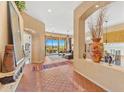 Spacious foyer with tile flooring leading to the living area, featuring a decorative niche and ample natural light at 9327 E Whitewing Dr, Scottsdale, AZ 85262