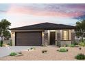 Charming single-story home featuring desert landscaping, a two-car garage, and a welcoming front porch with stone accents at 18220 W Daley Ln, Surprise, AZ 85387
