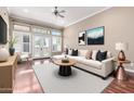 Bright living room with a ceiling fan, large windows, and a comfortable, stylish sofa at 333 N Pennington Dr # 55, Chandler, AZ 85224