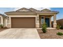Close up of a home's front exterior including the two car garage and desert landscaping at 10347 S Saguaro Dr, Apache Junction, AZ 85120