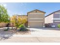 Two-story home with a tan stucco exterior, two-car garage, and low-maintenance desert landscaping at 1037 E Dust Devil Dr, San Tan Valley, AZ 85143