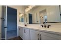 Bright bathroom featuring double sinks, modern hardware, and a large mirror for natural light at 11432 E Utopia Ave, Mesa, AZ 85212