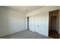 Neutrally painted bedroom with a closet and an open doorway leading to another room at 11432 E Utopia Ave, Mesa, AZ 85212