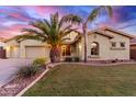 Charming single-Gathering home boasts a lush lawn, desert landscaping, and majestic palm trees at 1147 E Lodgepole Dr, Gilbert, AZ 85298