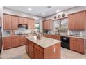 Spacious kitchen with granite countertops, wood cabinetry, and a center island at 1147 E Lodgepole Dr, Gilbert, AZ 85298