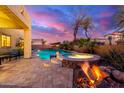Backyard pool and spa with cozy fire pit and desert landscaping, creating a relaxing outdoor oasis at 1147 E Lodgepole Dr, Gilbert, AZ 85298