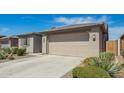 Two-car garage with desert landscaping on a sunny day at 11574 W Levi Dr, Avondale, AZ 85323