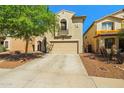 Two-story home featuring neutral stucco, a two-car garage, and desert landscaping in the front yard at 11732 W Foothill Dr, Sun City, AZ 85373
