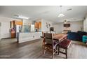 Spacious open-concept living and dining area with hardwood floors and modern decor at 11732 W Foothill Dr, Sun City, AZ 85373