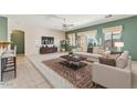 Staged living room featuring neutral walls, plush carpet, modern furniture, and an elegant area rug at 1245 E Waterview Pl, Chandler, AZ 85249