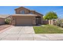 Inviting home with a two-car garage, manicured lawn, and attractive desert landscaping at 13416 S 47Th St, Phoenix, AZ 85044