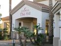 Exterior view of Solana Club 1941 entrance, featuring palm trees and desert landscaping at 1941 S Pierpont Dr # 2082, Mesa, AZ 85206