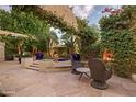Charming patio with climbing vines, seating area, and views of the landscaped garden, great for outdoor enjoyment at 22402 N 84Th Pl, Scottsdale, AZ 85255