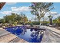 Sparkling pool surrounded by lush greenery, featuring lounge chairs and desert landscaping for a private oasis at 22402 N 84Th Pl, Scottsdale, AZ 85255