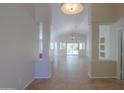 Bright, open-concept living room with tile flooring, neutral walls, and natural light streaming through large windows at 2456 E Hancock Trl, Casa Grande, AZ 85194