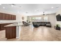 Open concept living space with tile flooring, a dining area, and a comfortable sectional sofa at 2831 W Carson Rd, Phoenix, AZ 85041