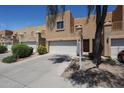 Home exterior highlighting a 2-car garage and desert-style landscaping in a community of attached homes at 2912 E Eberle Ln, Phoenix, AZ 85032