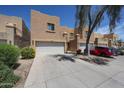 Home exterior showcasing a 2-car garage and desert-style landscaping in a community of attached homes at 2912 E Eberle Ln, Phoenix, AZ 85032