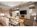 Open-concept living room with hardwood floors, neutral decor, and large windows for ample light at 29854 N 132Nd Dr, Peoria, AZ 85383