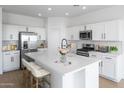 Beautiful kitchen with white cabinetry, stainless steel appliances, a large island, and modern finishes at 3974 E Ghost Flower Ln, San Tan Valley, AZ 85140