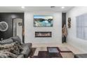 Modern living room with a sleek fireplace, stone accent wall, and stylish decor at 4115 S 75Th Dr, Phoenix, AZ 85043