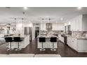Spacious kitchen featuring two large islands with seating, stainless steel appliances, and modern countertops at 5642 E Justine Rd, Scottsdale, AZ 85254