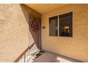 Close-up of the home's entrance, showcasing a charming wreath and a welcoming sunflower-themed doormat at 5877 N Granite Reef Rd # 1155, Scottsdale, AZ 85250