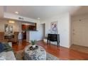 Open-concept living room and kitchen area with hardwood floors, modern decor, and abundant natural light at 5877 N Granite Reef Rd # 1155, Scottsdale, AZ 85250