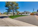 Lovely home with a well-manicured lawn and ample parking space on a sunny day at 7507 E Beatrice St, Scottsdale, AZ 85257