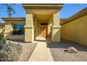 Inviting front entryway with decorative stone and a sheltered porch leading to the front door at 12733 S 177Th Ln, Goodyear, AZ 85338