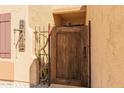 A weathered wooden gate providing access, complemented by desert decor and natural materials at 10322 E Excavation Ct, Gold Canyon, AZ 85118