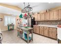 Well-lit kitchen with wood cabinets, a center island, and modern stainless-steel appliances at 10322 E Excavation Ct, Gold Canyon, AZ 85118