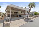 Charming home featuring a covered carport, desert landscaping, and a welcoming facade at 111 S Greenfield Rd # 313, Mesa, AZ 85206