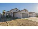 Inviting single-story home with well-kept landscaping and a two-car garage at 11835 W Windsor Ave, Avondale, AZ 85392