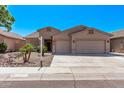 Charming single-story home featuring a two-car garage, desert landscaping, and a well-maintained front yard at 12941 W Flower St, Avondale, AZ 85392